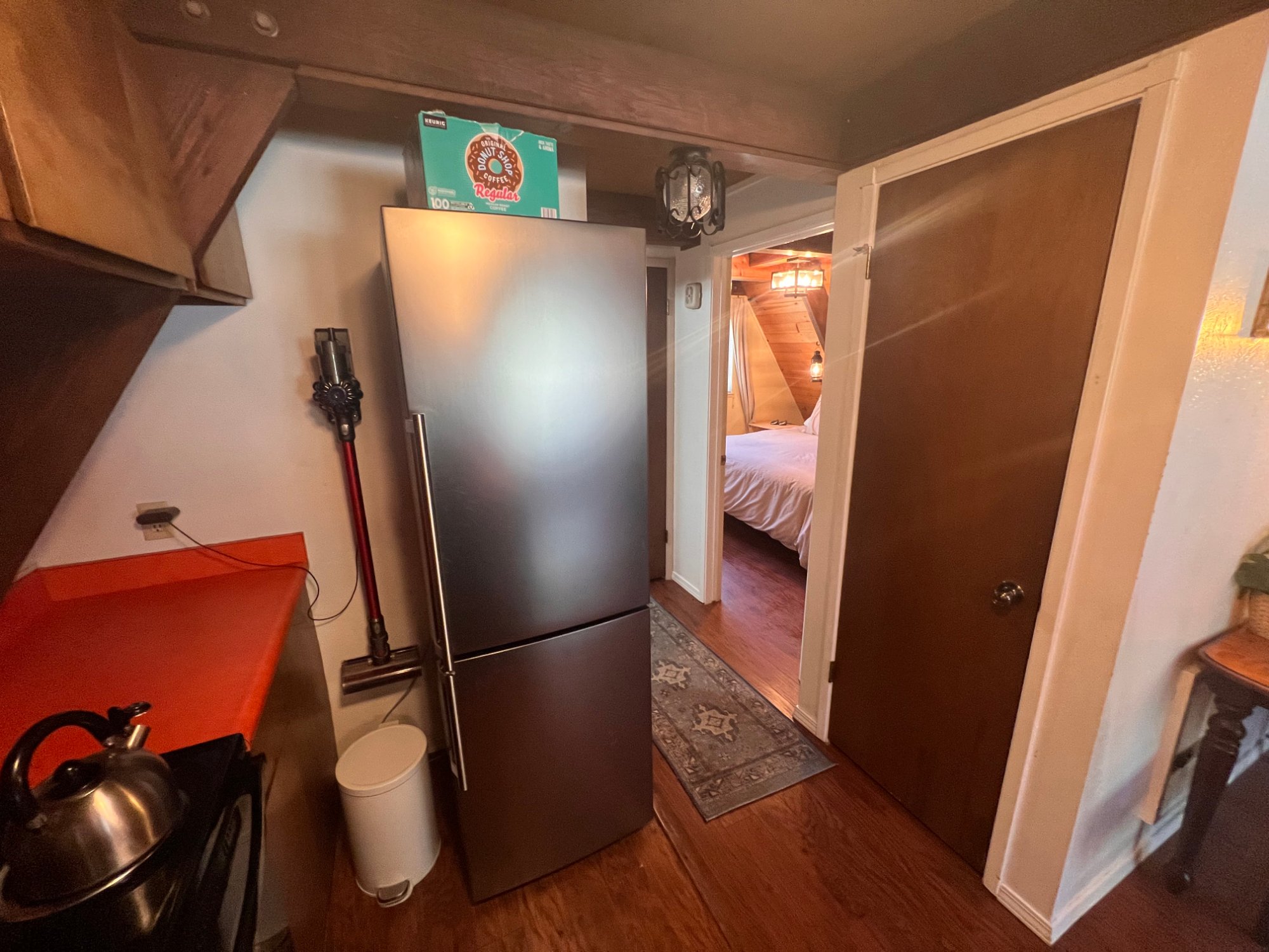 Kitchen hallway with fridge and bedroom view