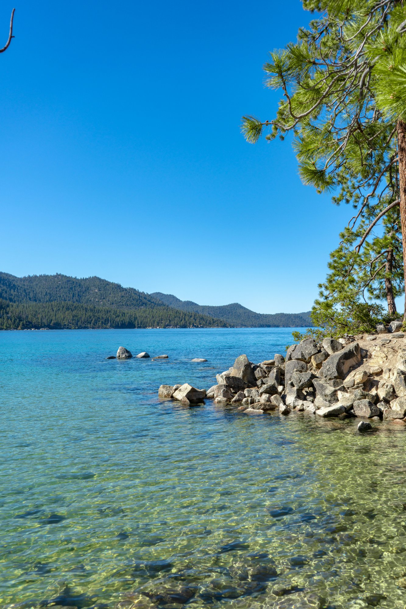 Crystal clear turquoise water of Lake Tahoe with mountain views
