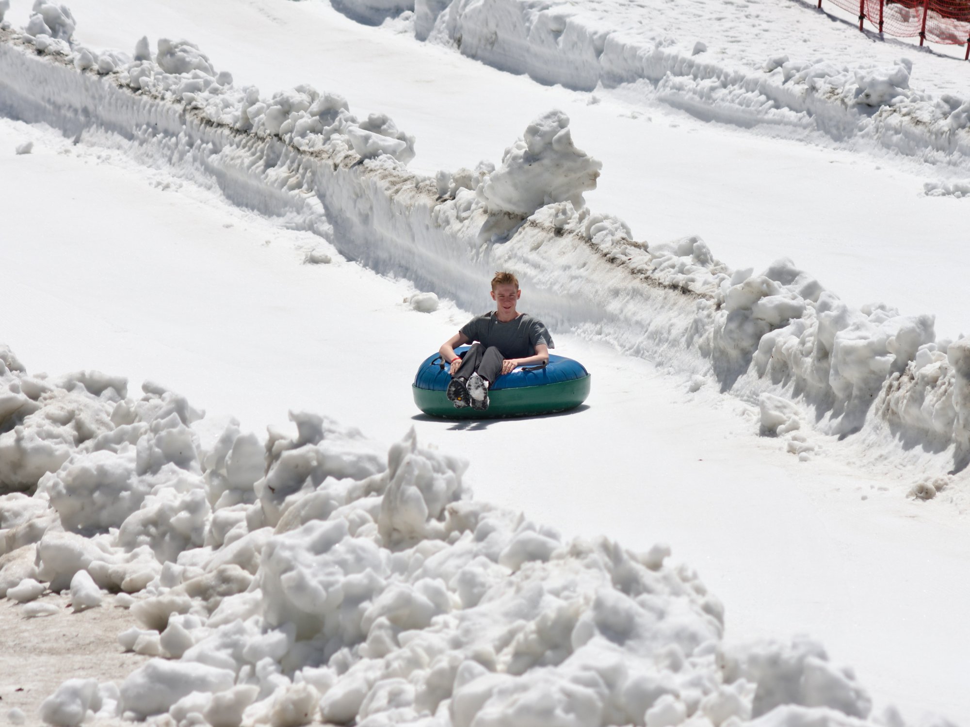 Snow tubing down a snowy hillside